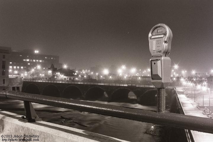 A portrait of a parking meter over the Genesee River in Rochester, NY
